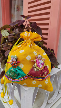 YELLOW BANDHINI COTTON POTLI BAG WITH HAND MADE PUPPETS