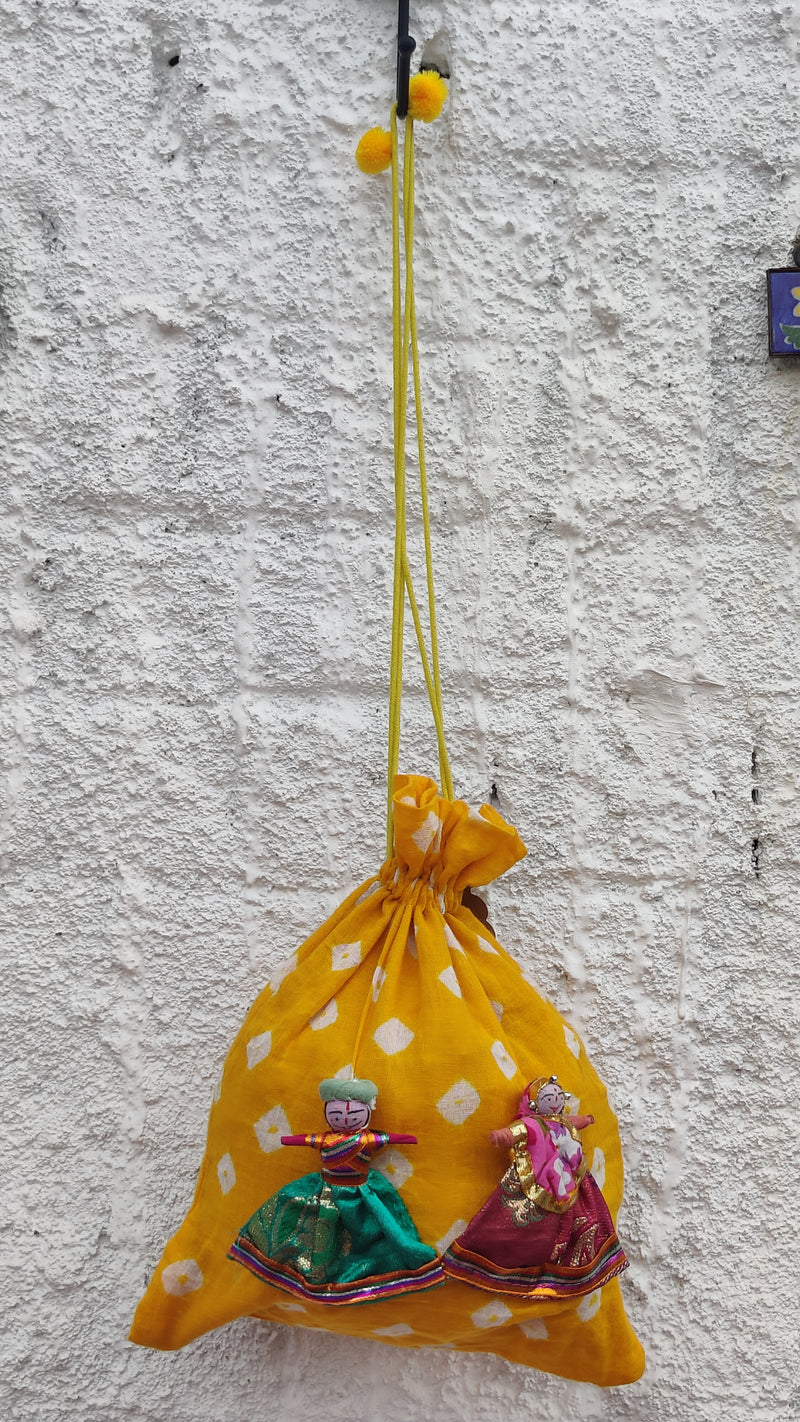 YELLOW BANDHINI COTTON POTLI BAG WITH HAND MADE PUPPETS